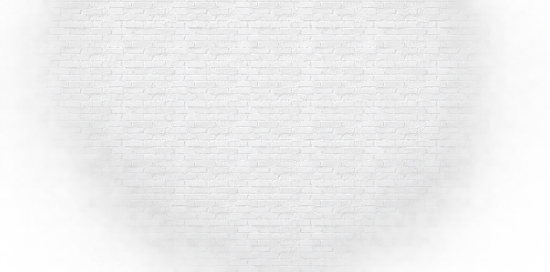 Un mur de briques peintes en blanc, vu de face, avec une texture légère et uniforme.